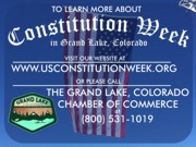 A thumb nail view of Grand Lake, Colorado during Constitution Week in September looking at the Town Park Sign and the Garrison Flag that hangs over Grand Ave. on parade day with inforomation on how to contact the Grand Lake Chamber of Commerce; click here to open a window with a larger picture.
